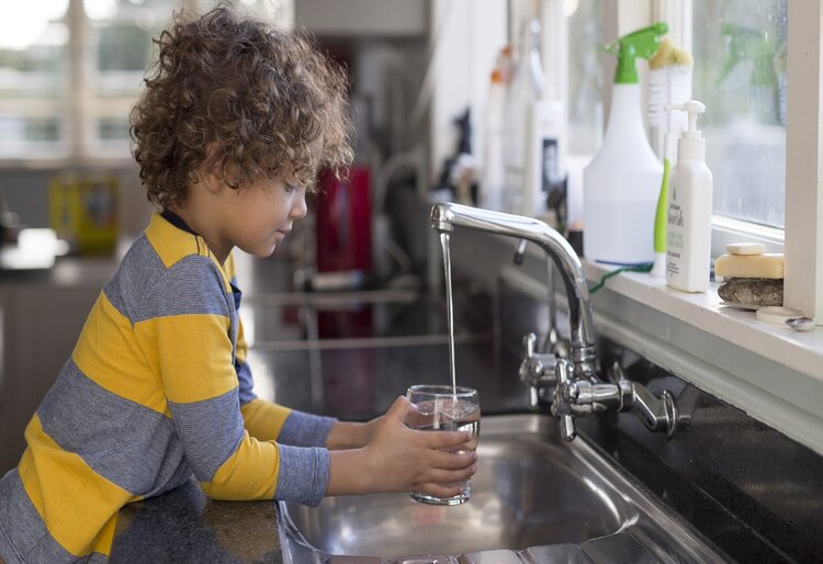 Boy pouring a glass of water
